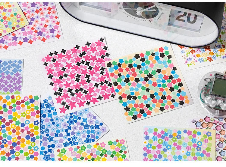 A collection of colorful star-shaped mini deco cut film stickers displayed on a white surface next to a measuring tool.