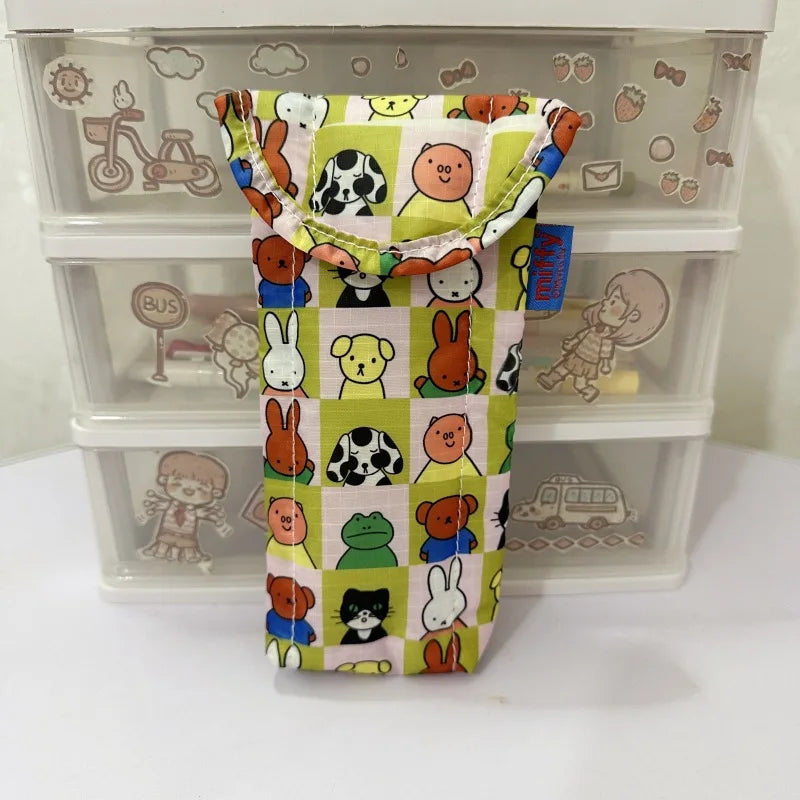 A yellow and green magnetic storage bag featuring various cartoon animal characters for kids.