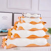 A stack of orange and white plush cat pillows for sofa and bed