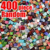 A pile of 400 random magnetic building cubes in various colors and patterns.