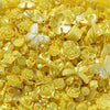 A close-up of yellow and gold butterfly shell acrylic beads for DIY jewelry making.
