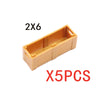 Two pieces of 2x6 wooden building blocks shaped like a treasure chest, used for construction.