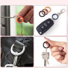 Close-up shots of colorful alloy snap hook keychain clips and a silver key on a black bag.