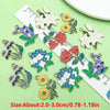 A collection of colorful enamel flower charms displayed on a ruler for size reference.