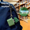 A green duck and frog fidget clicker keychain attached to a dark blue backpack
