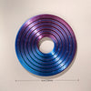 A 3D printed rainbow spinner ring with concentric grooves in shades of purple and blue.