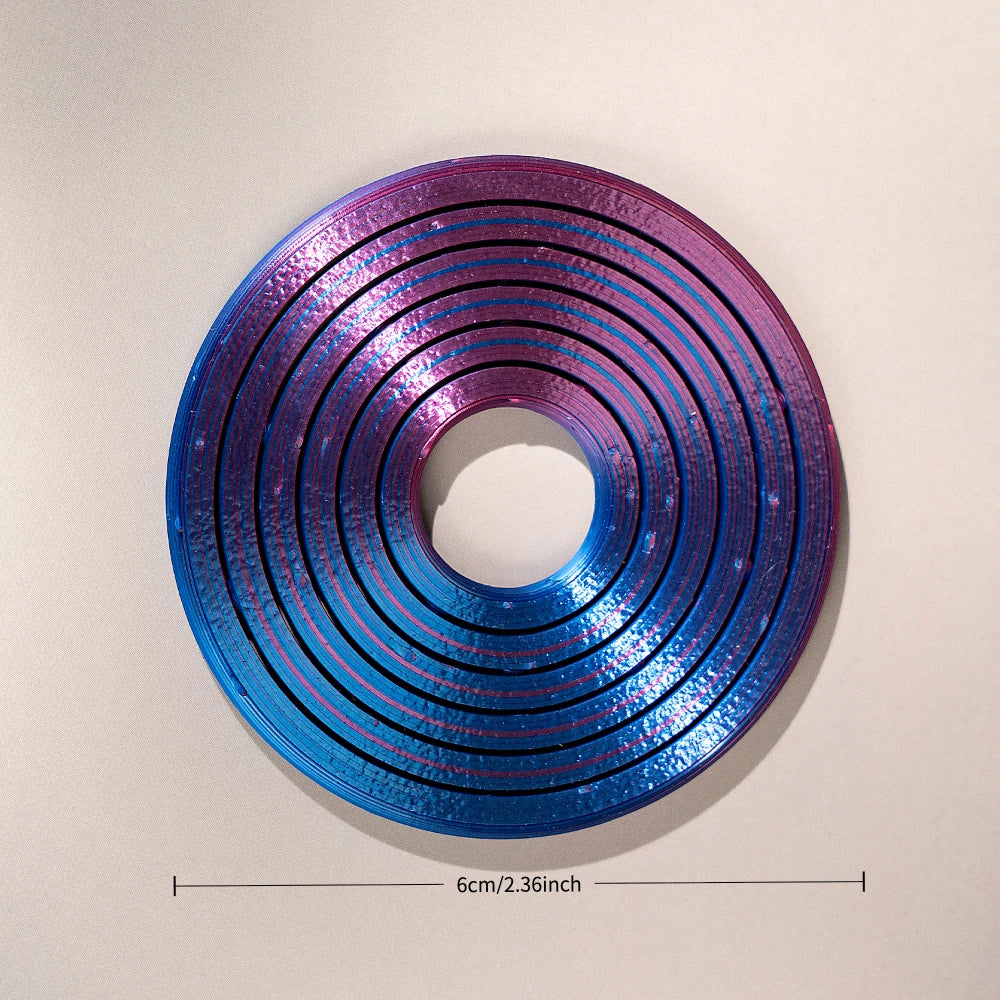 A 3D printed rainbow spinner ring with concentric grooves in shades of purple and blue.