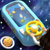 A hand is gripping a yellow steering wheel on a blue toy vehicle that simulates space travel with stars and planets visible t