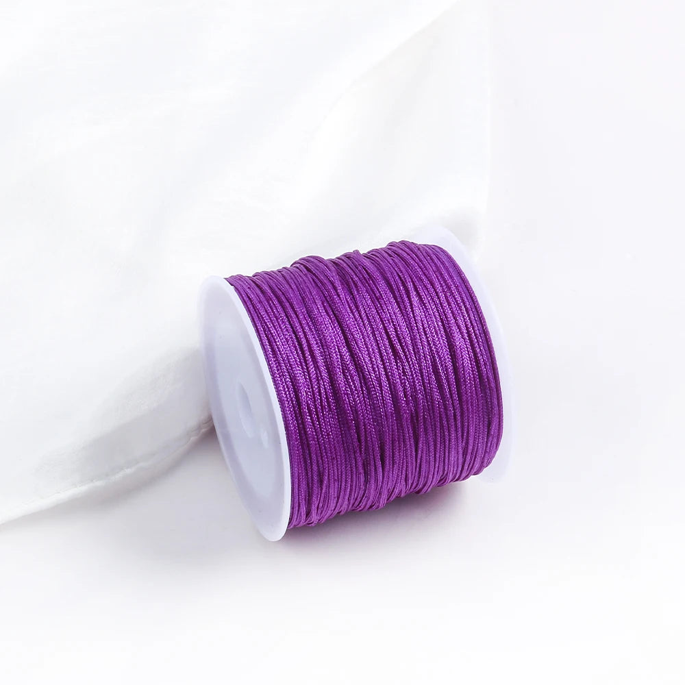 A roll of purple 0.8mm cotton nylon macrame cord for jewelry making and crafts.