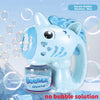A light blue unicorn-themed bubble machine is shown with a bottle and a blue silicone gun, surrounded by soap bubbles.