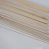 A collection of thin, light-colored natural solid wood strips laid diagonally on a white surface.