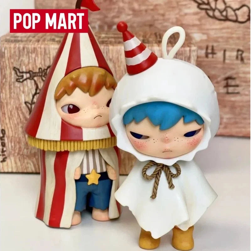 A collectible figurine of a character wearing a striped hat and white cloak with blue hair.