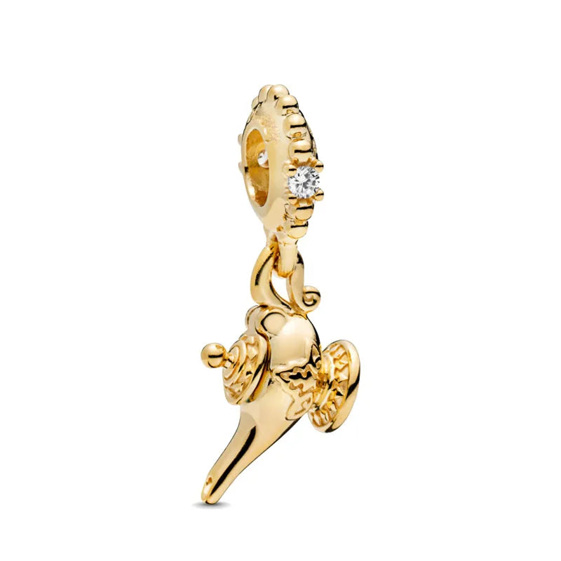 Gold charm bracelet featuring pendants of an elephant, key, butterfly, and heart.