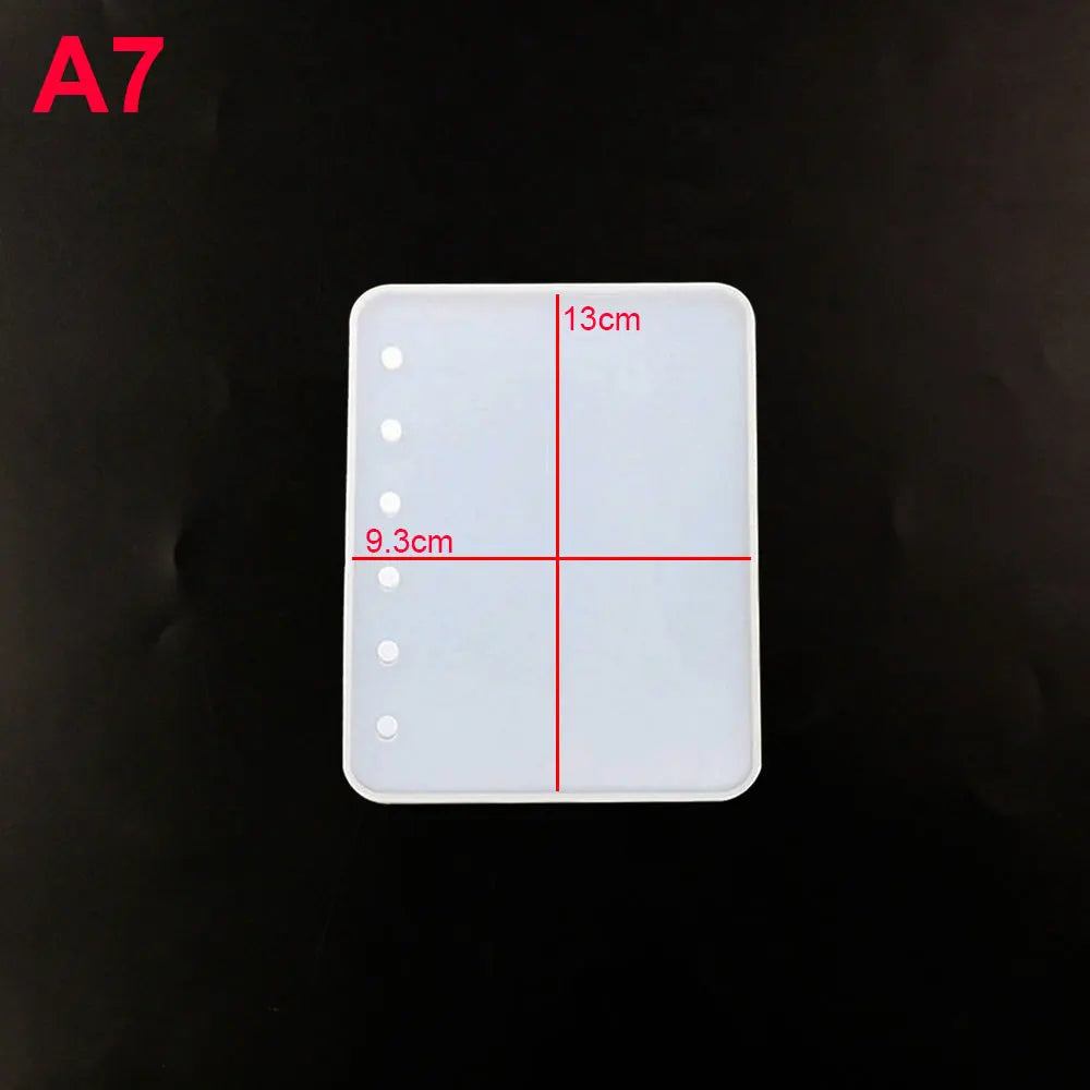A silicone mold for an epoxy resin notebook cover with dimensions marked 13cm and 9.3cm.