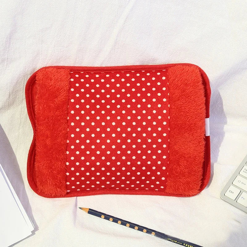A bright red cozy rechargeable hot water bottle with a soft, fuzzy cover and a white polka-dot fabric insert.