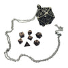 A metal polyhedral dice set with a pendant storage case, featuring a large dodecahedron die.
