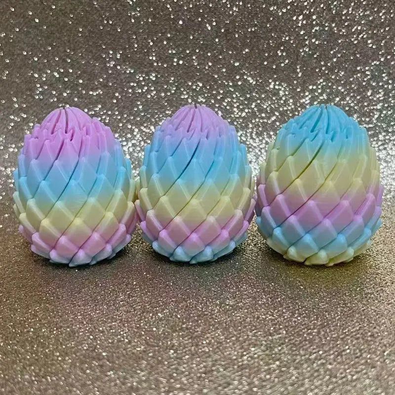 Trois œufs de dragon aux couleurs pastel pour la relaxation, disposés en rang sur une surface scintillante.