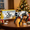 A silver robotic dog toy is displayed on a wooden table next to its packaging and holiday decorations.