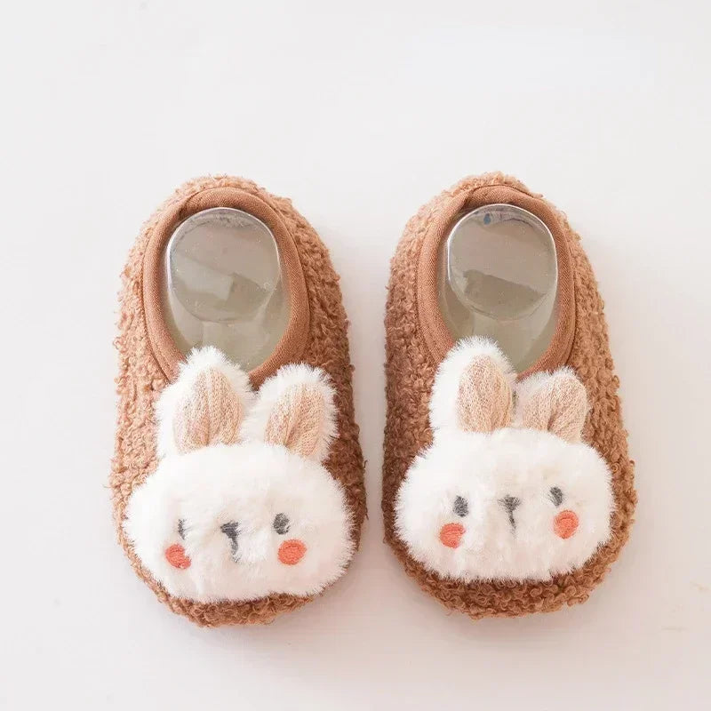 Pair of brown fuzzy bunny plush baby slippers with anti-slip soles