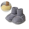 Gray suede baby booties with knitted cuffs and a plush fur lining shown next to a yellow bootie.