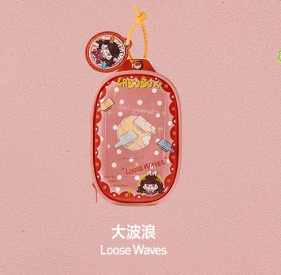 A pink pendant keychain featuring a LABUBU doll and text that reads Loose Waves