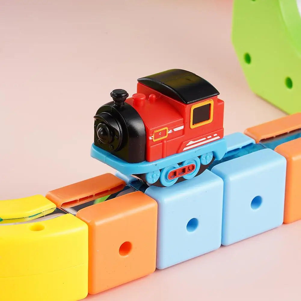A red and black magnetic train engine toy with a blue track section and yellow components.
