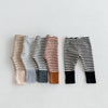 A collection of soft cotton baby leggings featuring various striped designs in brown, gray, and black.
