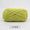 A ball of light green pre-dyed milk cotton yarn used for knitting and crochet.