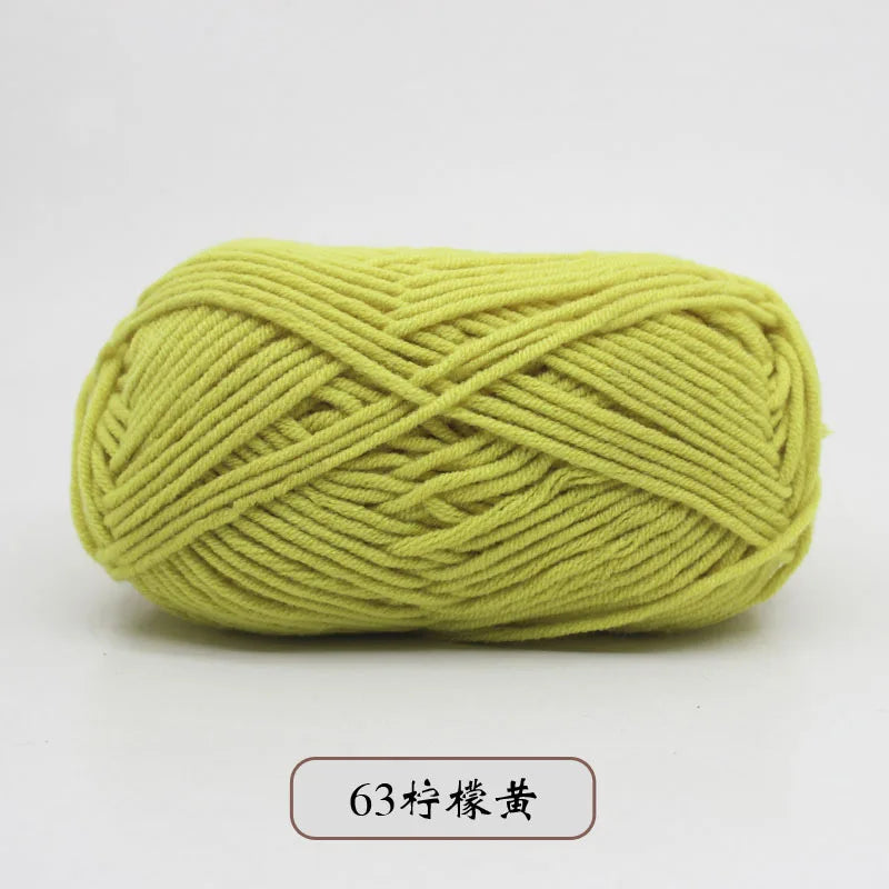 A ball of light green pre-dyed milk cotton yarn used for knitting and crochet.