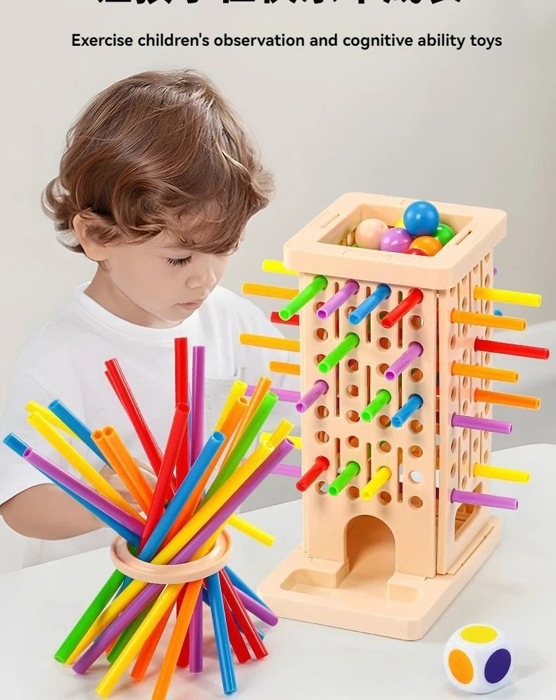 A wooden stacking tower game with colorful rods and balls is shown next to a child's hand.