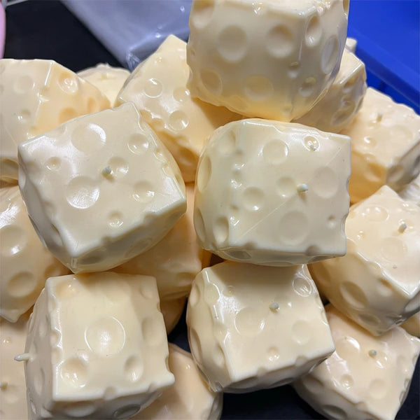 A pile of white, squishy stress balls or fidget toys with dimpled surfaces.