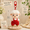 A handmade crochet donkey doll in red and white, displayed next to a motivational card.