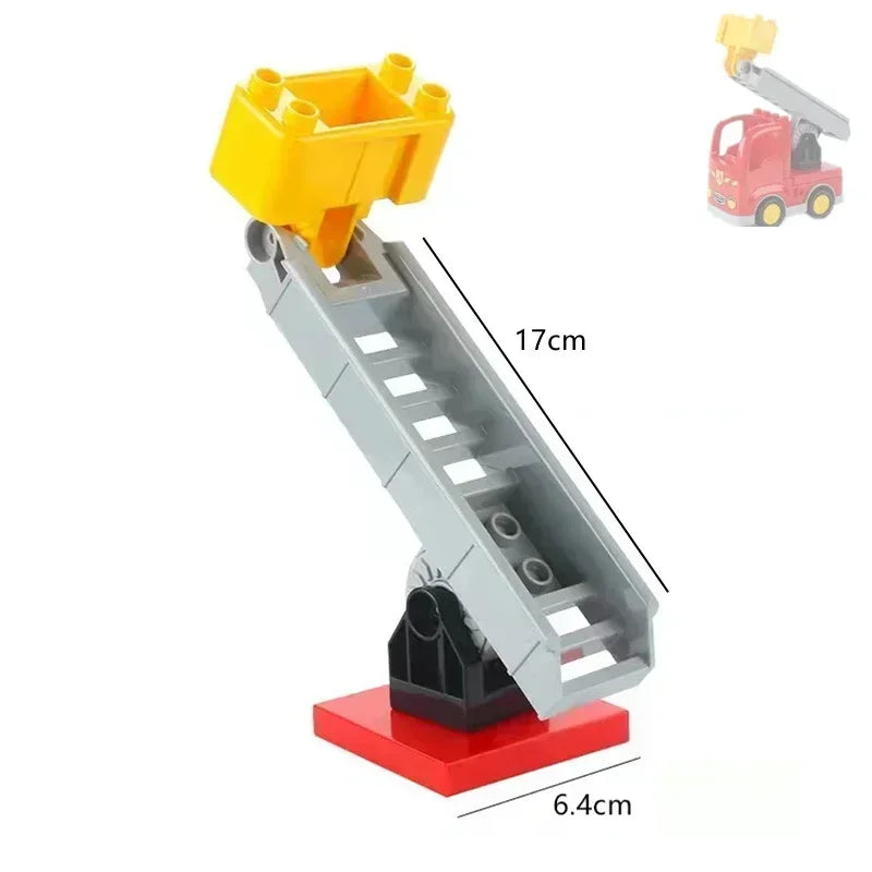 A gray building block ramp structure with a yellow platform and a red base, shown next to a small red construction vehicle.