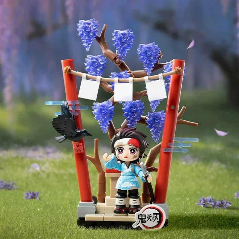A collectible blind box figure of a Demon Slayer character with dark hair and blue clothing, displayed in a natural outdoor s