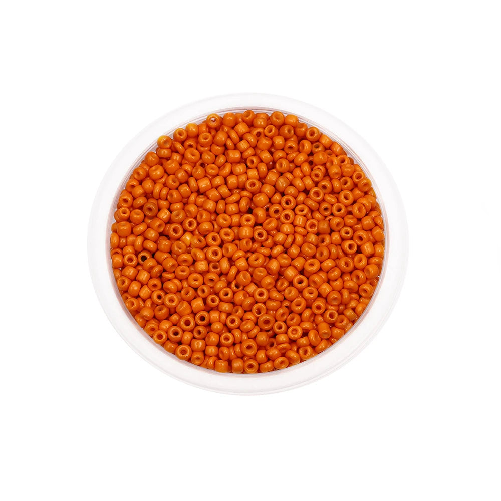 A clear container filled with small, round, orange glass seed beads for jewelry making.
