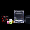 A clear cube and several colored dice are displayed on a black background.