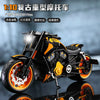A detailed 1:10 scale die-cast motorcycle model in black and orange, featuring working lights and sound effects.