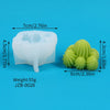 A white silicone mold shaped like a cactus or succulent is shown next to a green, textured silicone product.
