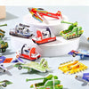 A collection of colorful foam puzzle pieces shaped like various animals and vehicles, including planes, tanks, and boats, arr