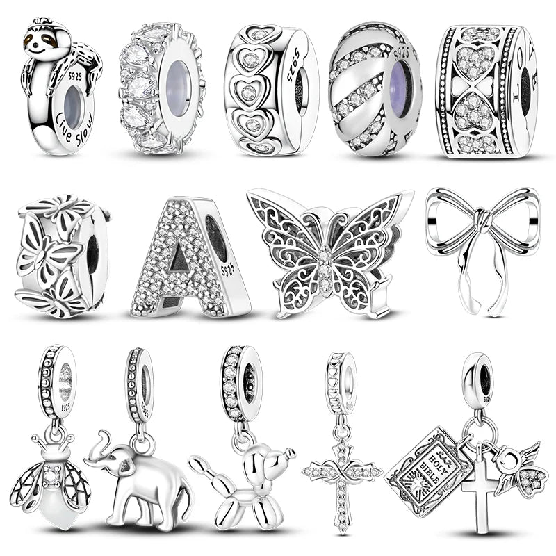 A collection of sterling silver charm beads and pendants for DIY jewelry making including floral, animal, and religious motif