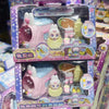 A packaged collectible figure of a pink and purple train with an aurora theme featuring a small doll.