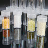 A collection of clear plastic storage bottles filled with various colored beads and craft materials for diamond painting