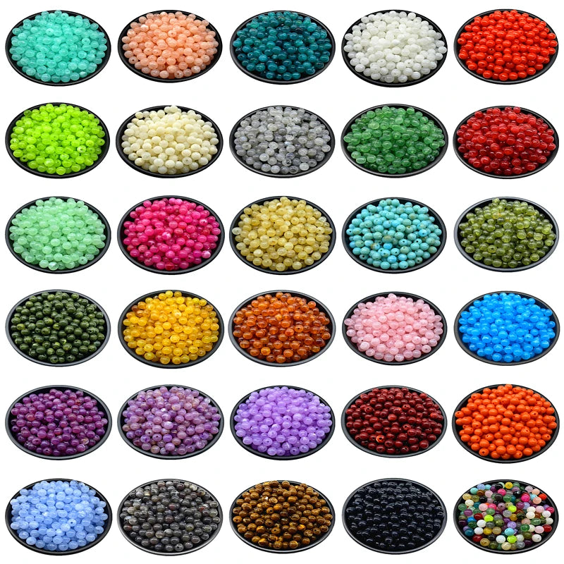 A grid of various colors and sizes of acrylic round beads for jewelry making