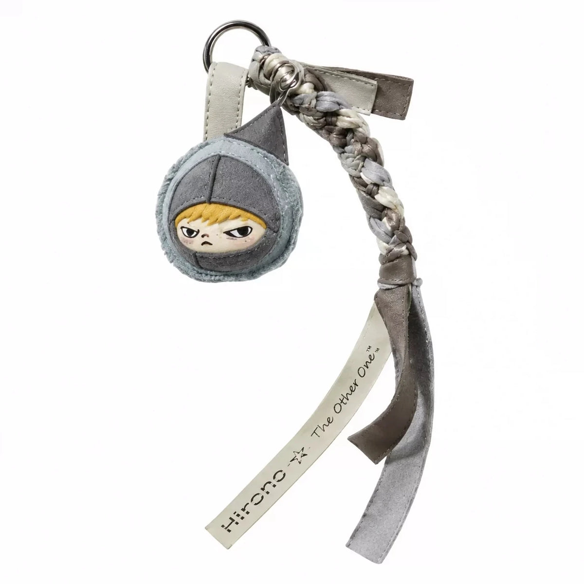 A blind box keychain featuring a gray head with yellow eyes and a textured, braided strap.
