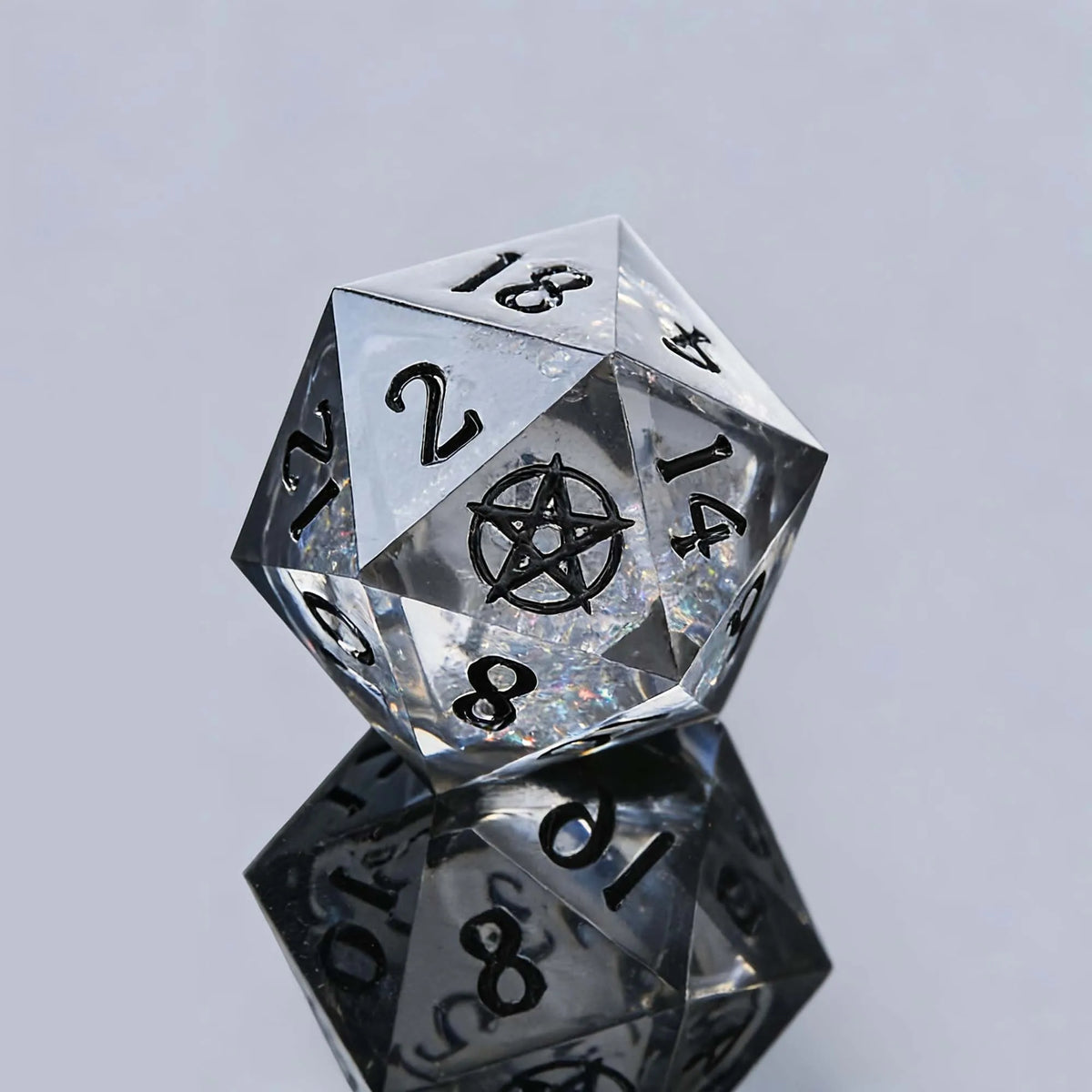 A translucent, faceted d20 polyhedral die with a pentagram symbol on one face, resting on a reflective surface.