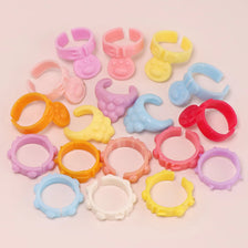 A collection of ten mini pet collar accessories in various pastel colors including pink, yellow, purple, and blue.