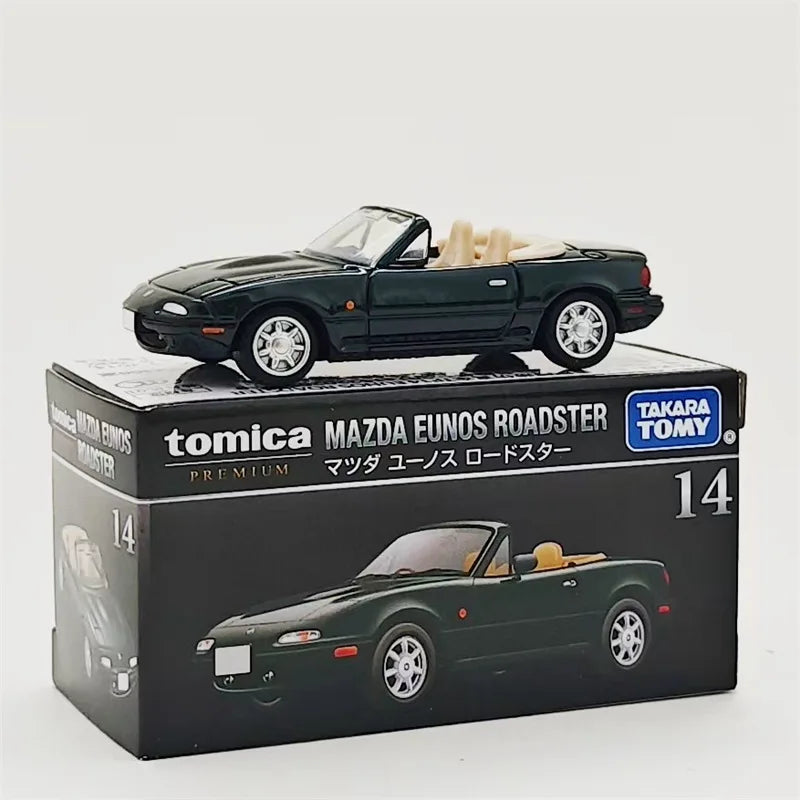 Tomica Mazda Eunos Roadster die-cast model in dark green on a black box.
