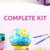 A complete kit for a DIY 3D moon night light craft featuring various colorful paints, tools, and a spherical moon object.