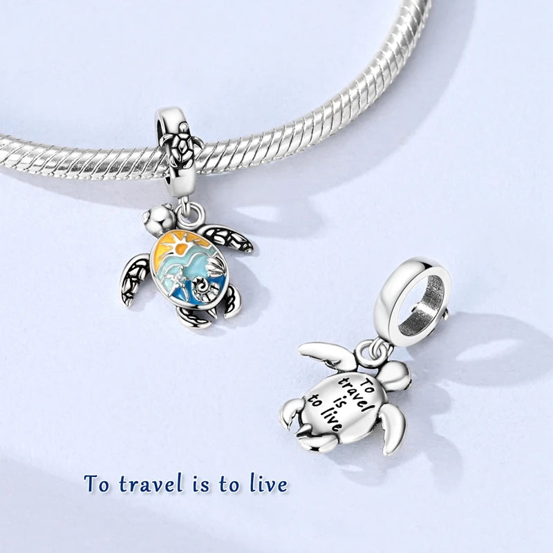 Sterling silver charm pendant set featuring starfish, sea turtle, and whale shark designs on a silver chain.