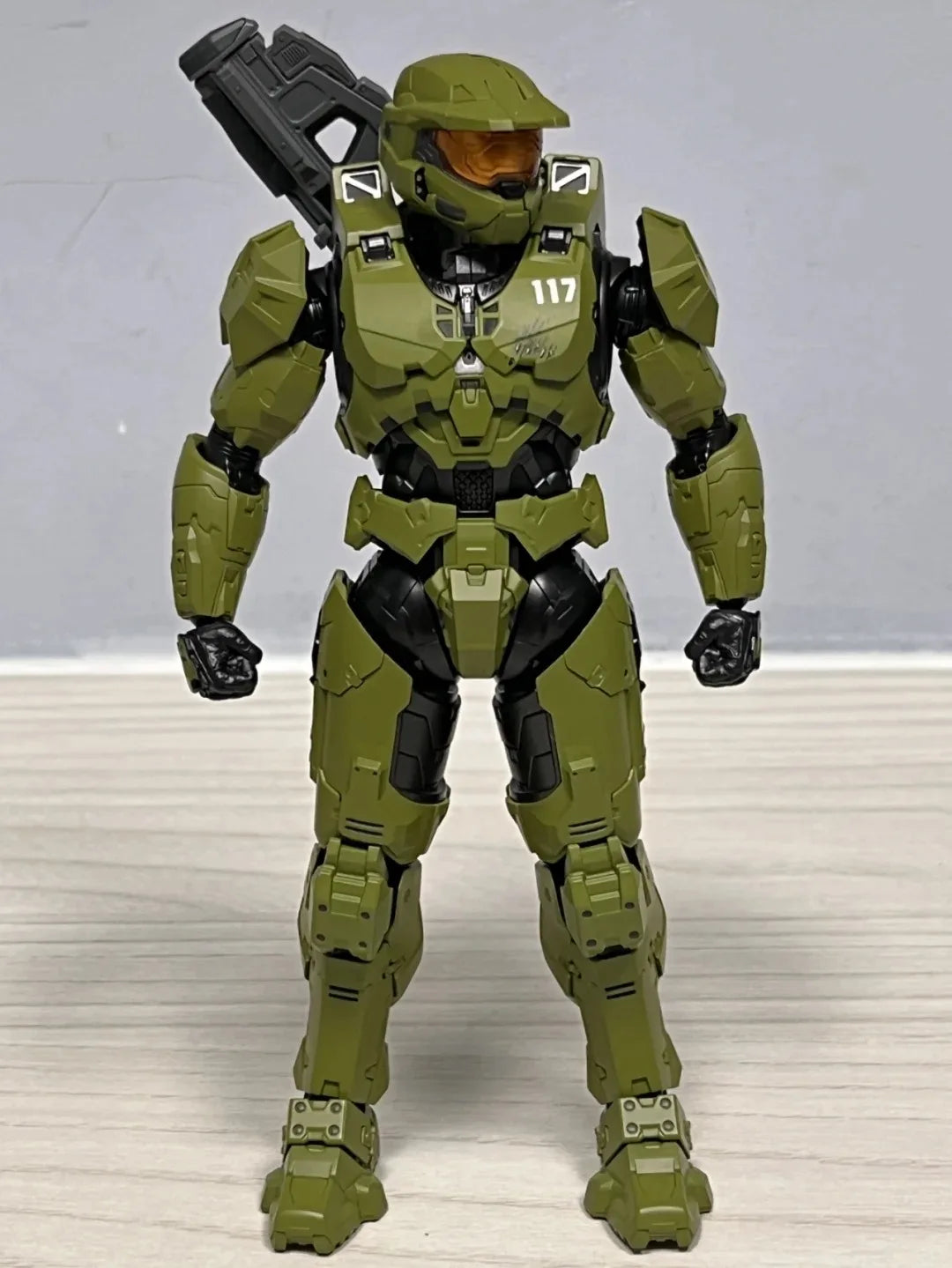 A 1/12 scale Master Chief action figure in olive green armor standing upright.